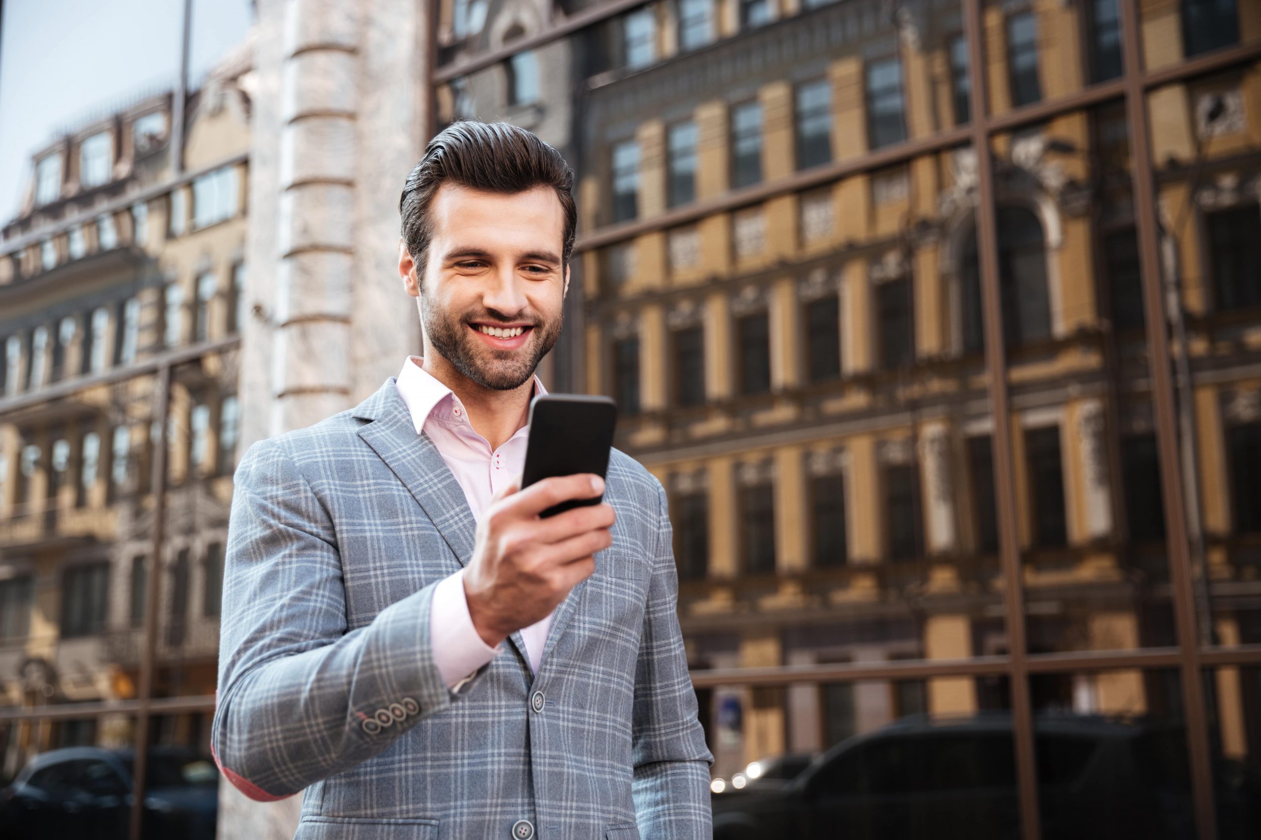 man in jacket looking at his mileage tracking app