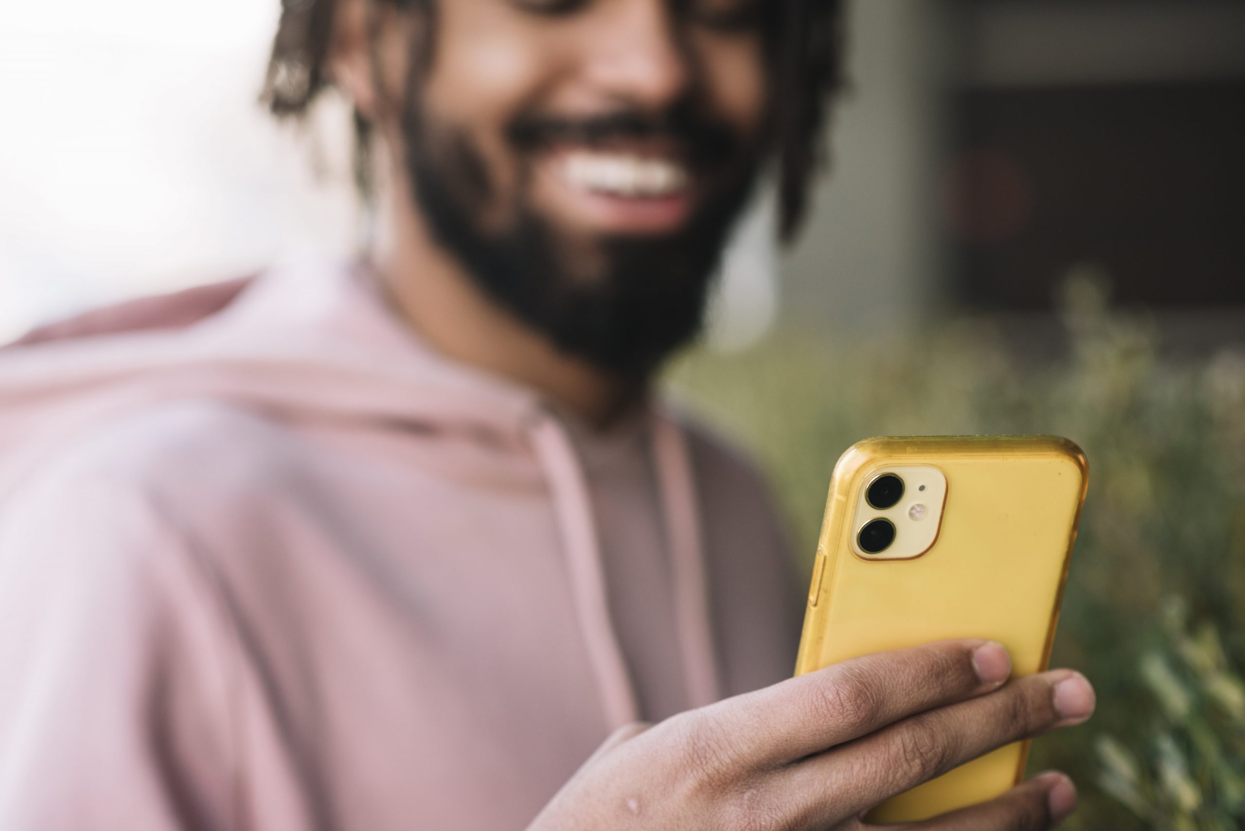 happy man looking at mileage tracker app on iphone