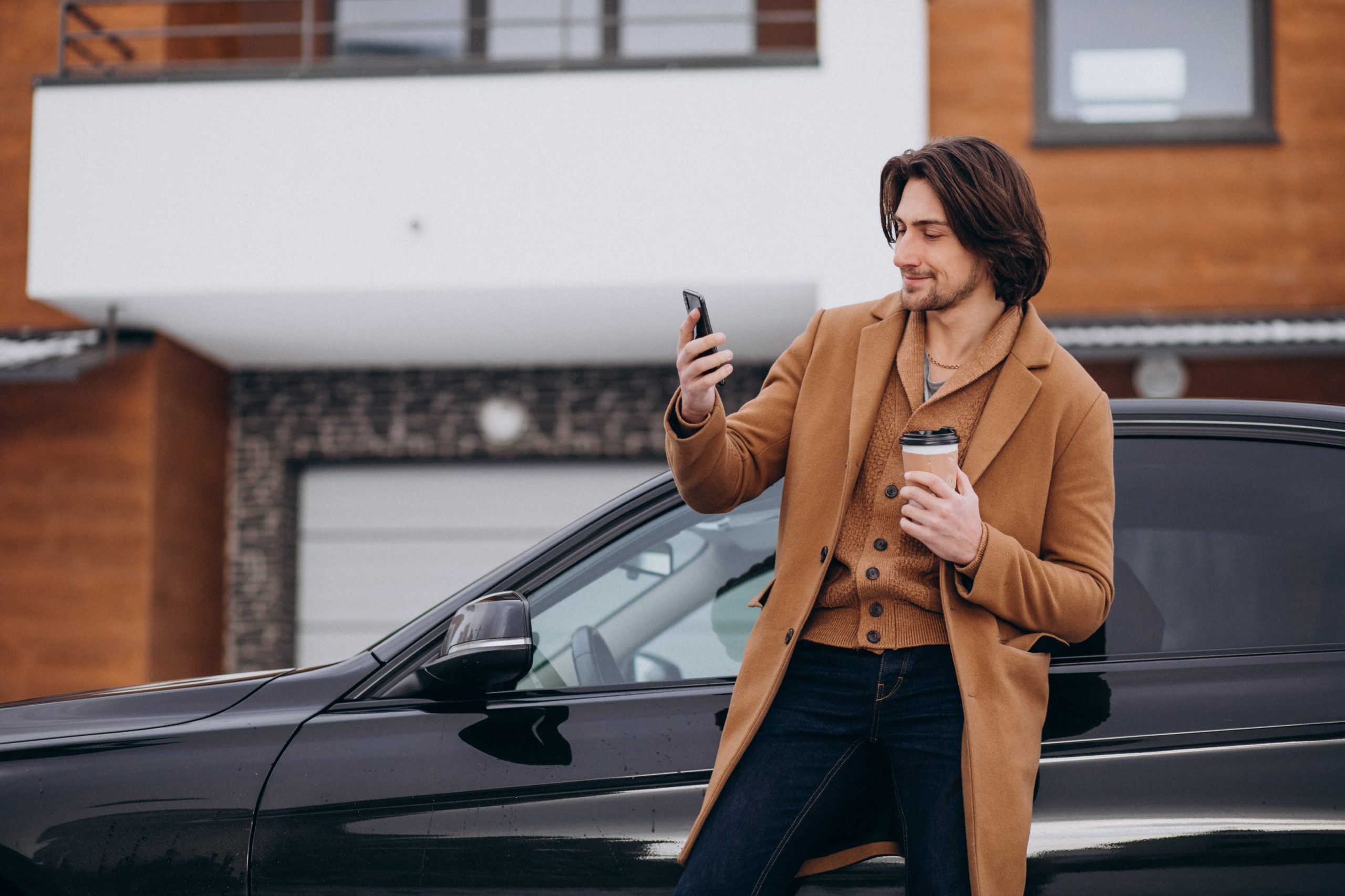 young-handsome-man-talking-phone-by-his-car-min (1)