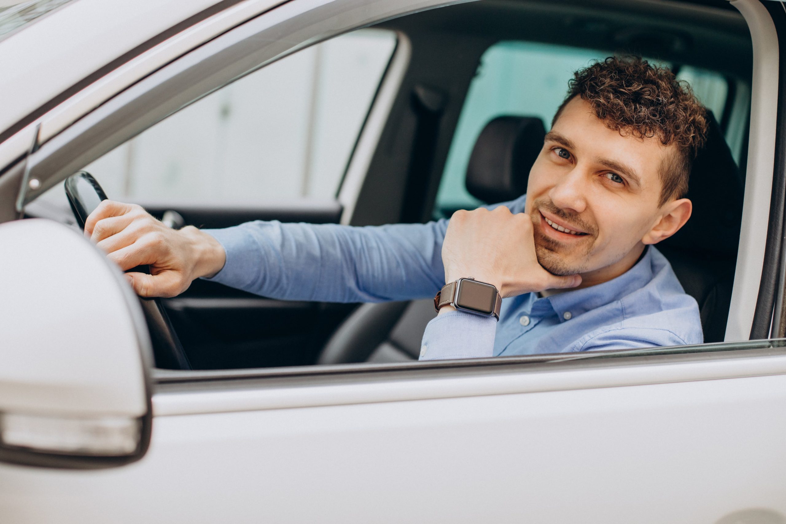 man in car using mileage tracker app