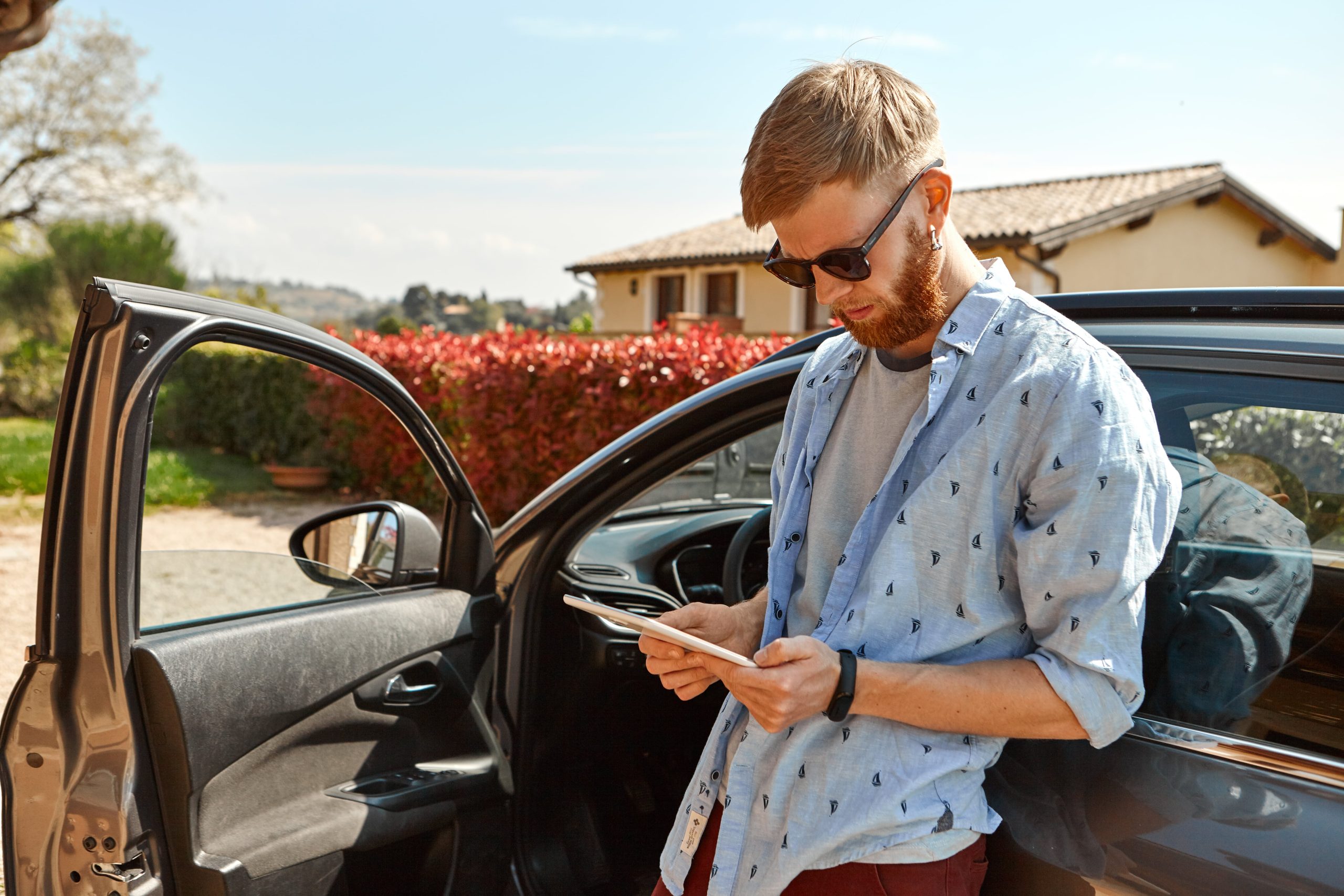outdoor-image-handsome-trendy-hipster-guy-with-fuzzy-beard-standing-his-car-min