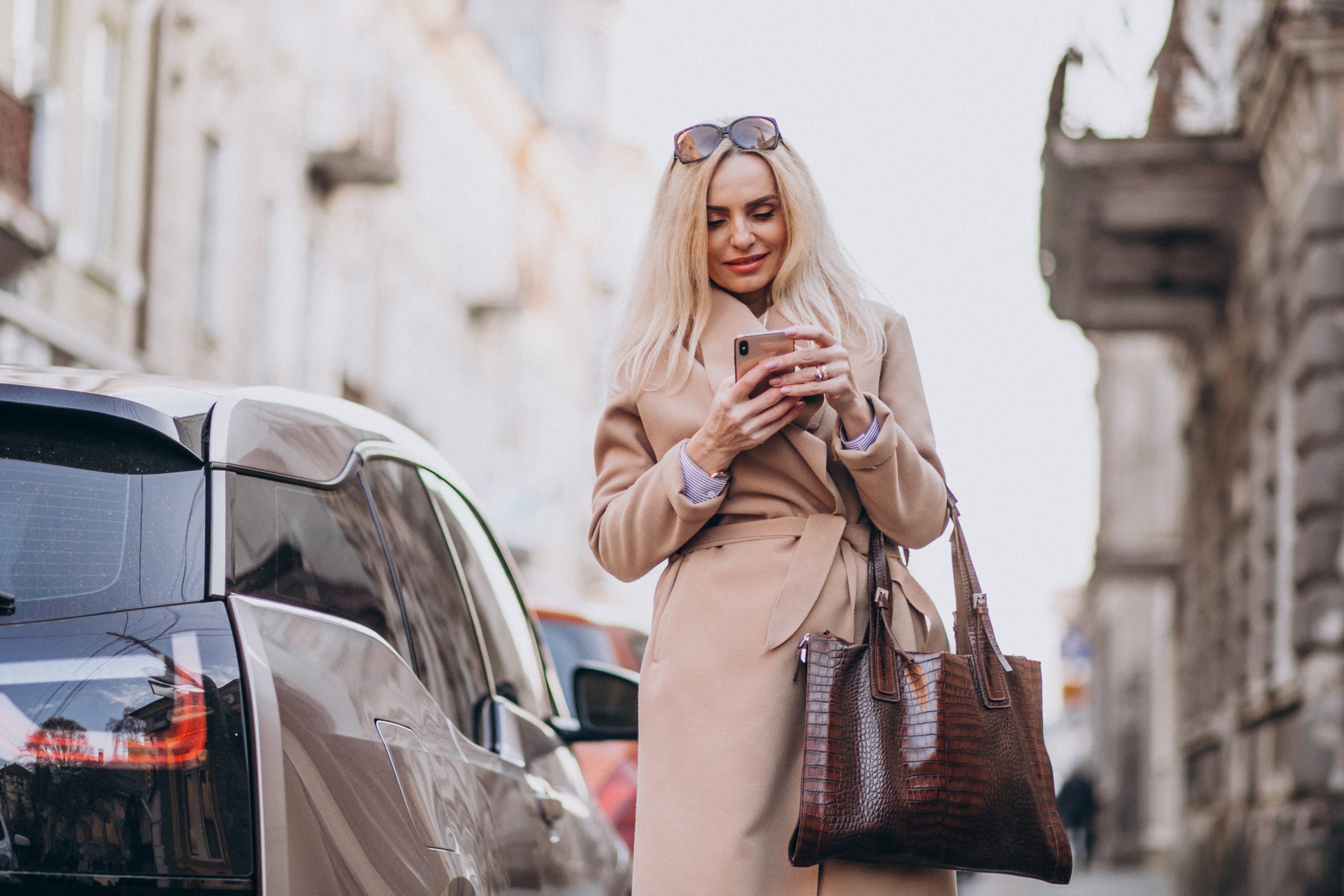 Smiling entrepreneur tossing aside her outdated Excel mileage log, embracing the efficient, automatic tracking of MileageWise for a hassle-free driving experience.