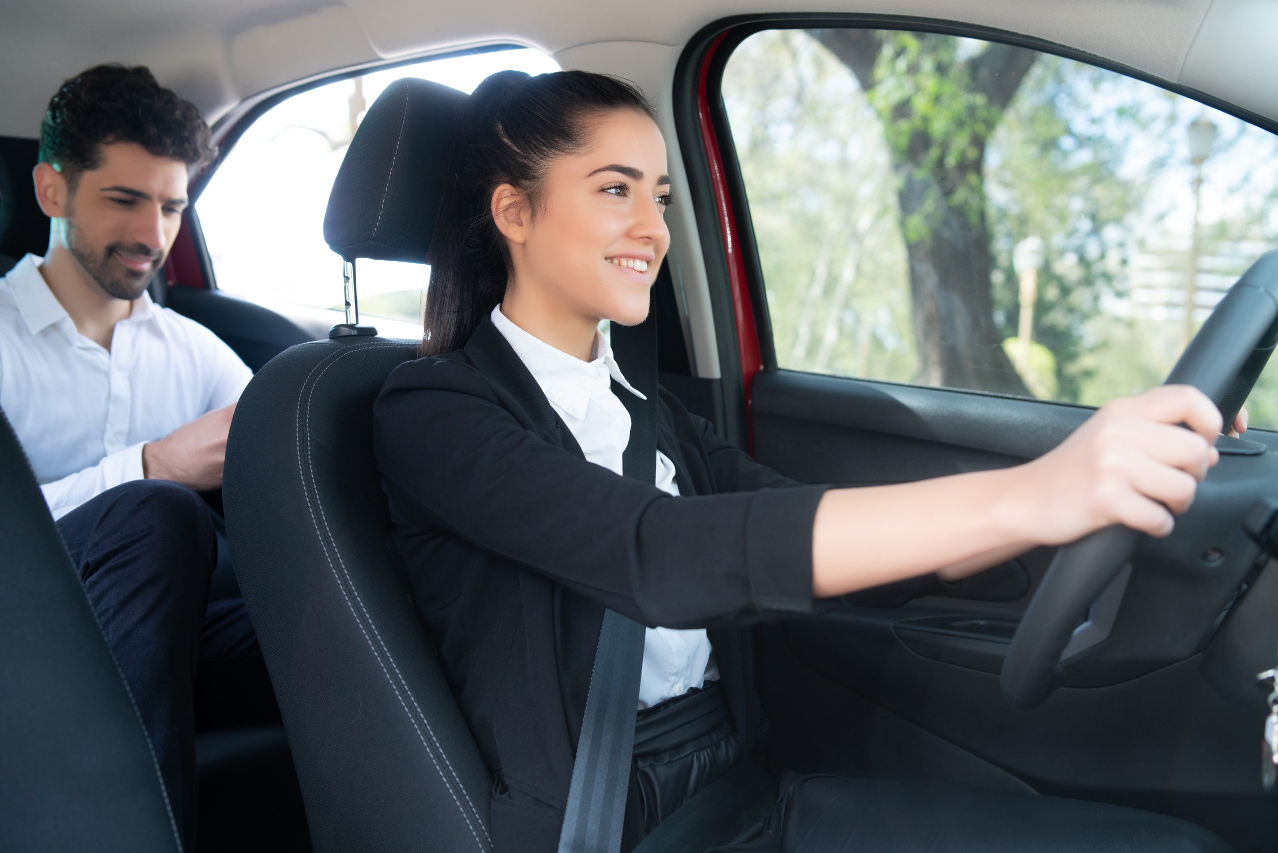 An Uber driver confidently navigating the city streets, their eyes focused on the road ahead while their trusty smartphone, equipped with the MileageWise app records every mile.