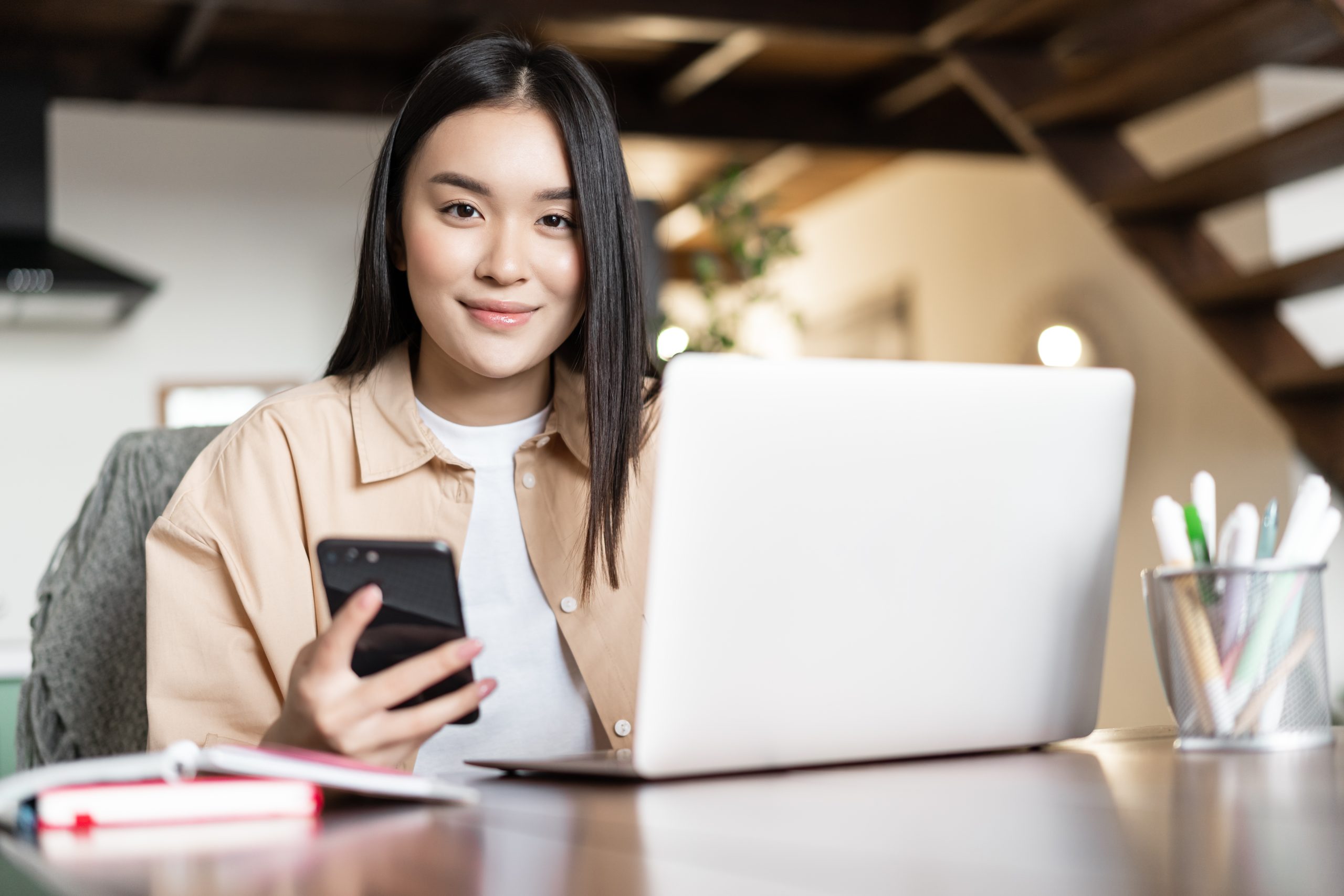 A focused businesswoman at her home office uses the MileageWise app to easily calculate her business mileage for taxes, demonstrating the app's user-friendly design and efficient tax deduction management.