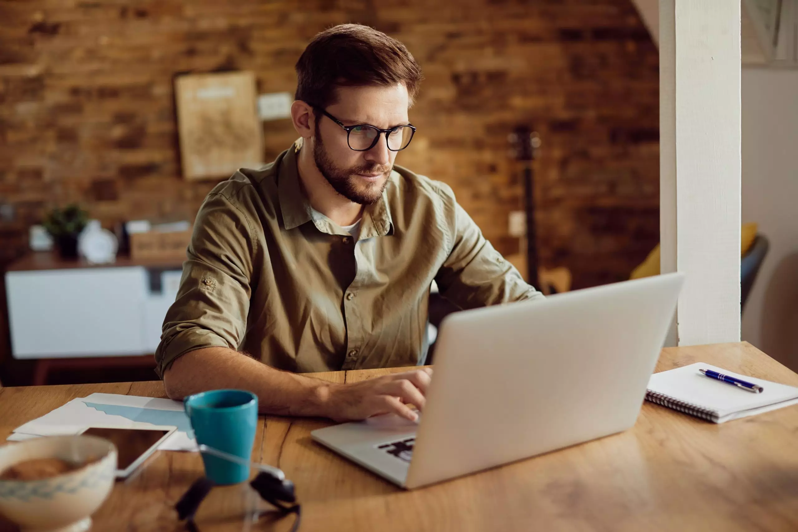 male entrepreneur working on laptop at home