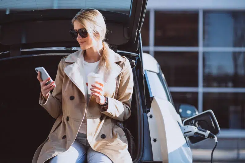 woman checking a miles log app on phone