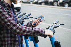 A Bird scooter charger picks up a drained scooter A Bird scooter charger picks up a drained scooter